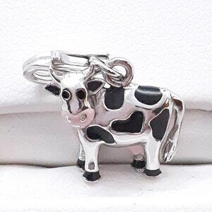 New 925 sterling silver and enamel cow charm.  Lobster claw clasp.